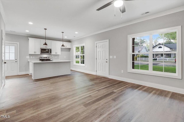 1307 S 14th St, Lillington, NC 27546 - unfurnished living room featuring ornamental molding, plenty of natural light, light wood finished floors, a ceiling fan, and recessed lighting