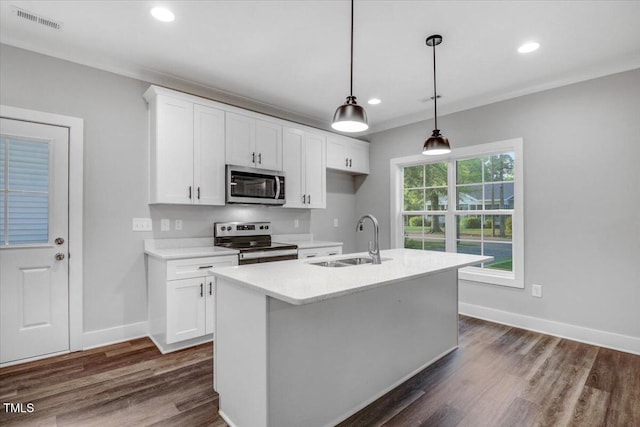 1307 S 14th St, Lillington, NC 27546 - kitchen with stainless steel appliances, white cabinets, recessed lighting, a center island with sink, and light countertops