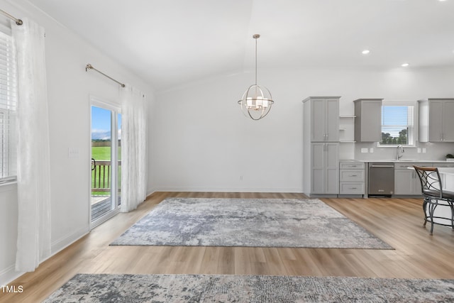 6109 Oak Passage Dr, Raleigh, NC 27603 - unfurnished dining area with a chandelier, lofted ceiling, light wood-style flooring, and recessed lighting