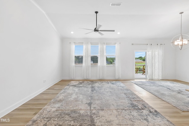 6109 Oak Passage Dr, Raleigh, NC 27603 - unfurnished living room featuring ceiling fan, a chandelier, light wood-type flooring, and recessed lighting