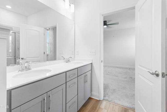 6109 Oak Passage Dr, Raleigh, NC 27603 - bathroom with a ceiling fan, double vanity, and wood finished floors