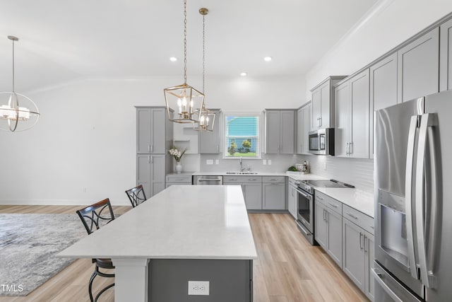 6109 Oak Passage Dr, Raleigh, NC 27603 - kitchen with stainless steel appliances, gray cabinetry, a chandelier, recessed lighting, and crown molding