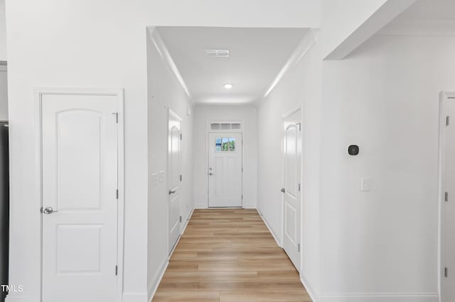 6109 Oak Passage Dr, Raleigh, NC 27603 - doorway with light wood finished floors, crown molding, and recessed lighting