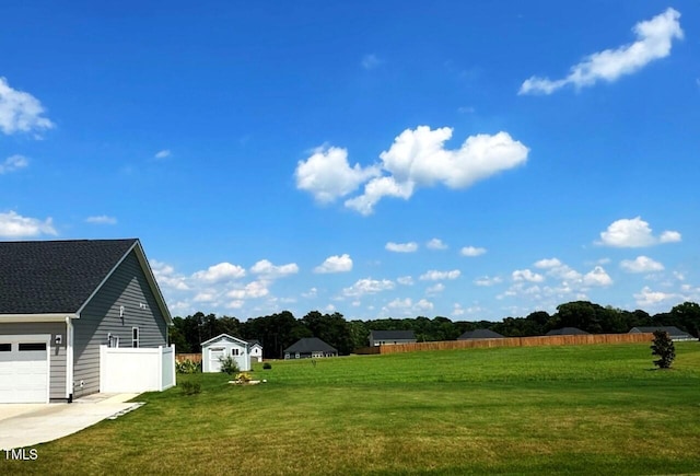 6109 Oak Passage Dr, Raleigh, NC 27603 - view of yard with driveway, a storage unit, and a garage