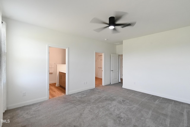 6109 Oak Passage Dr, Raleigh, NC 27603 - unfurnished bedroom with carpet flooring, a spacious closet, connected bathroom, and a ceiling fan