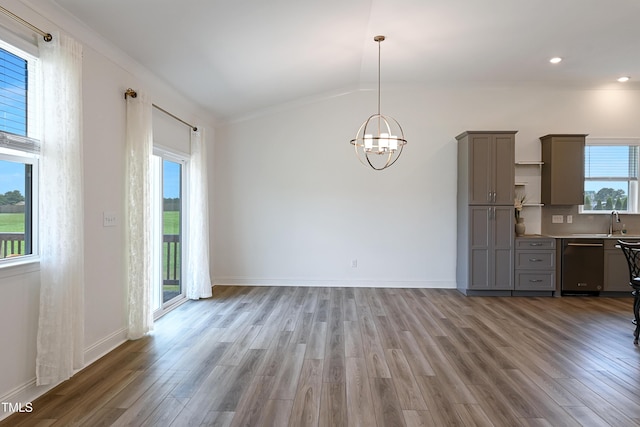 6109 Oak Passage Dr, Raleigh, NC 27603 - unfurnished dining area featuring wood finished floors, a chandelier, vaulted ceiling, ornamental molding, and recessed lighting