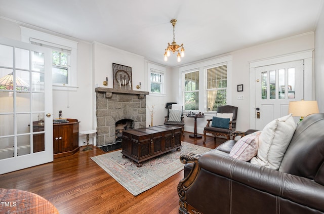 513 Cutler St, Raleigh, NC 27603 - living area with wood finished floors, plenty of natural light, ornamental molding, and a stone fireplace