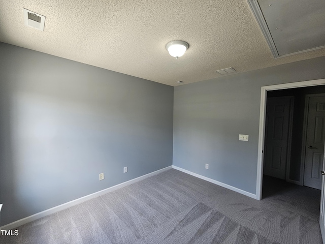 121 Brentfield Loop, Morrisville, NC 27560 - spare room featuring attic access, dark colored carpet, and a textured ceiling