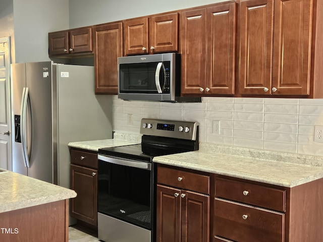 121 Brentfield Loop, Morrisville, NC 27560 - kitchen featuring stainless steel appliances, light countertops, and decorative backsplash