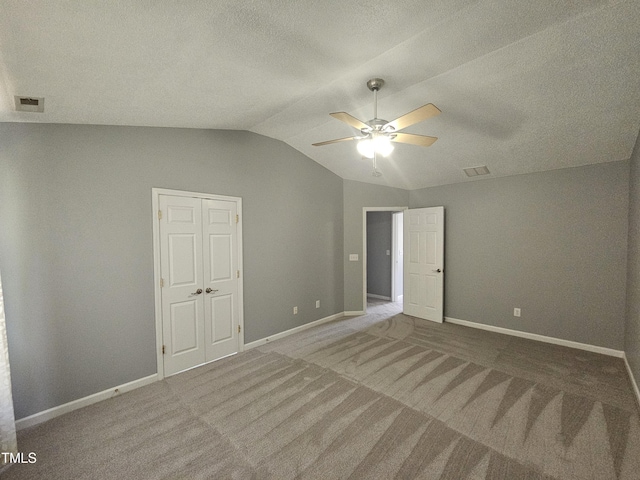 121 Brentfield Loop, Morrisville, NC 27560 - unfurnished bedroom with lofted ceiling, carpet flooring, ceiling fan, and a textured ceiling