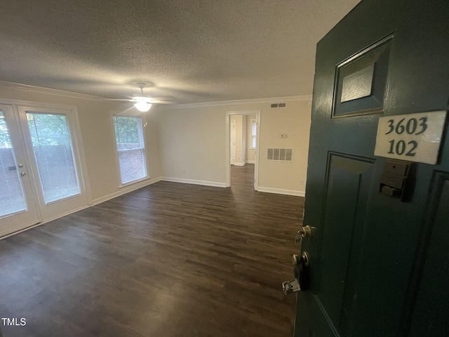 3603 Helix Ct Unit 102, Raleigh, NC 27606 - empty room featuring crown molding, a textured ceiling, dark wood-style floors, and a ceiling fan