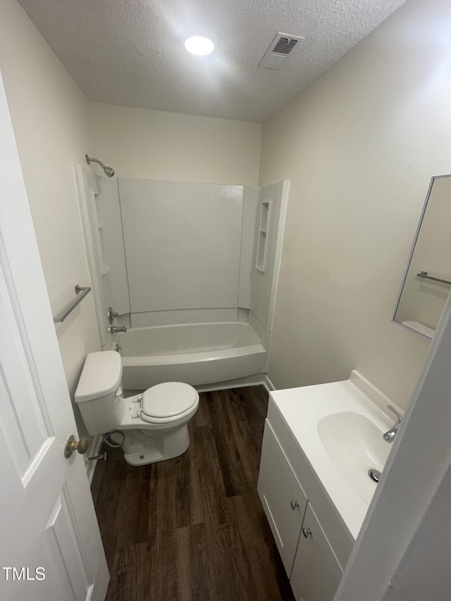 3603 Helix Ct Unit 102, Raleigh, NC 27606 - full bath with wood finished floors, a textured ceiling, vanity, and shower / washtub combination