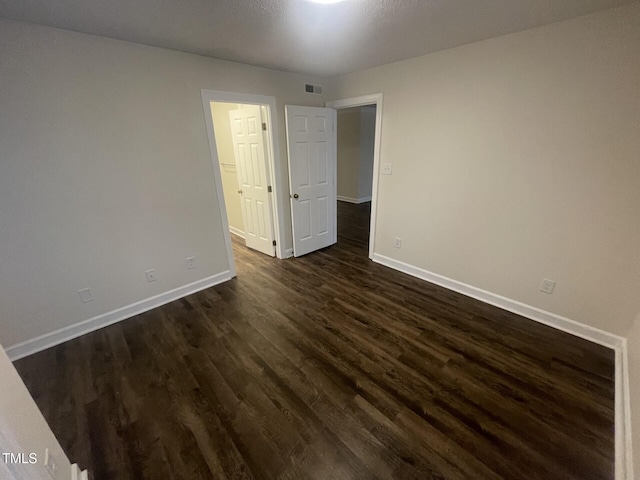 3603 Helix Ct Unit 102, Raleigh, NC 27606 - unfurnished room featuring baseboards and dark wood-style floors