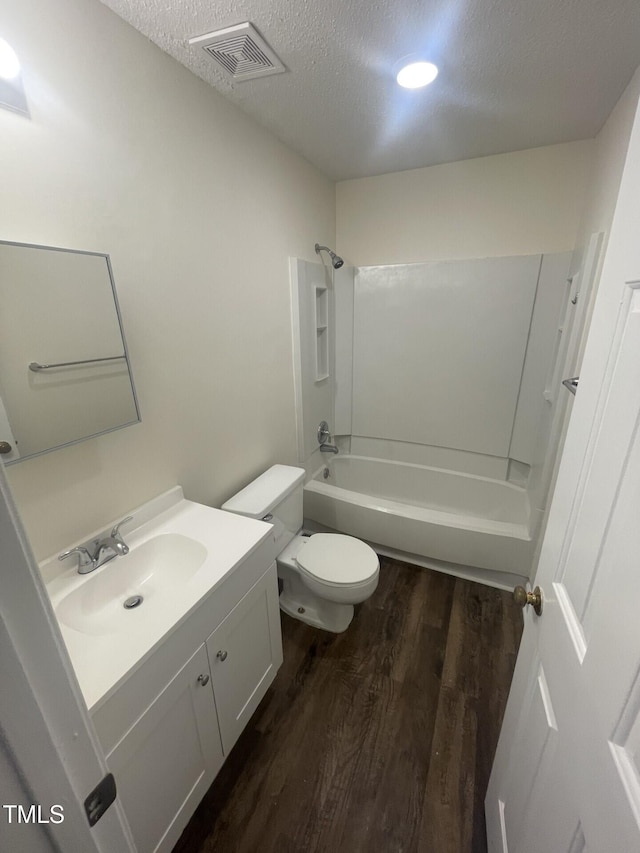 3603 Helix Ct Unit 102, Raleigh, NC 27606 - full bath featuring wood finished floors, vanity, a textured ceiling, and bathtub / shower combination