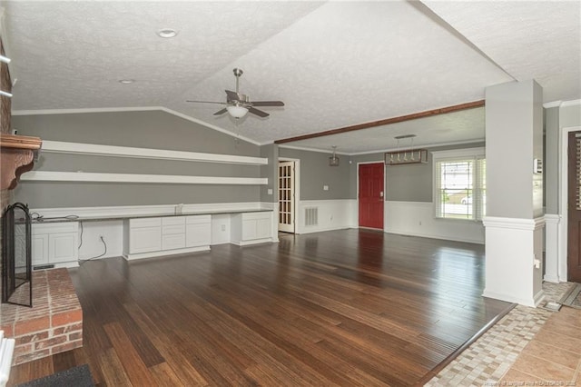 5621 Monks Walk Ct, Fayetteville, NC 28311 - unfurnished living room with a textured ceiling, ceiling fan, a wainscoted wall, ornamental molding, and wood finished floors