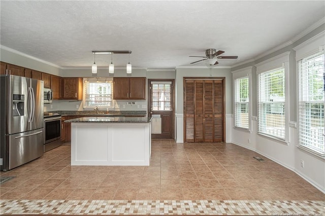 5621 Monks Walk Ct, Fayetteville, NC 28311 - kitchen with stainless steel appliances, ornamental molding, plenty of natural light, ceiling fan, and light tile patterned floors