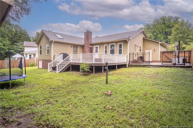 5621 Monks Walk Ct, Fayetteville, NC 28311 - rear view of property featuring a trampoline, a wooden deck, a chimney, and stairway