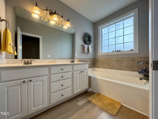 71 Beaver Creek Dr, Dunn, NC 28334 - bathroom featuring double vanity, wood finished floors, and a bath