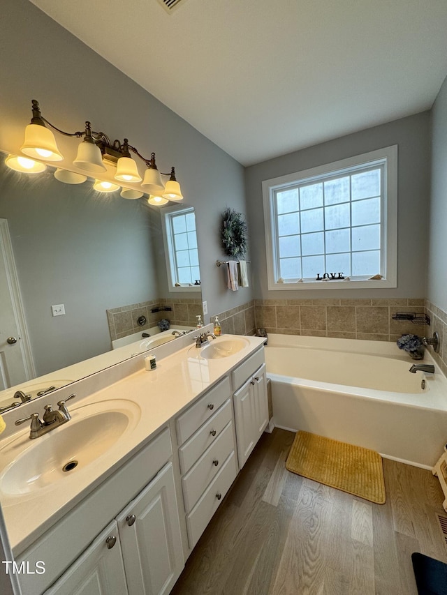 71 Beaver Creek Dr, Dunn, NC 28334 - full bathroom featuring wood finished floors, a garden tub, and double vanity