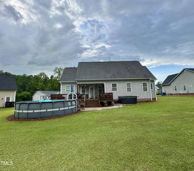 71 Beaver Creek Dr, Dunn, NC 28334 - back of property with a hot tub, a wooden deck, a lawn, and an outdoor pool