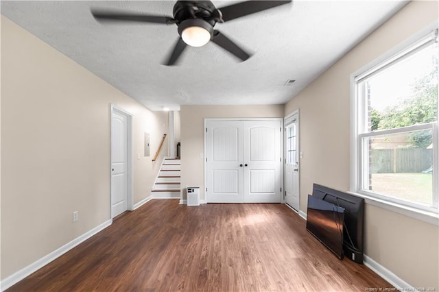 1524 Stackhouse Dr, Fayetteville, NC 28314 - unfurnished living room with wood finished floors, ceiling fan, stairs, a textured ceiling, and electric panel