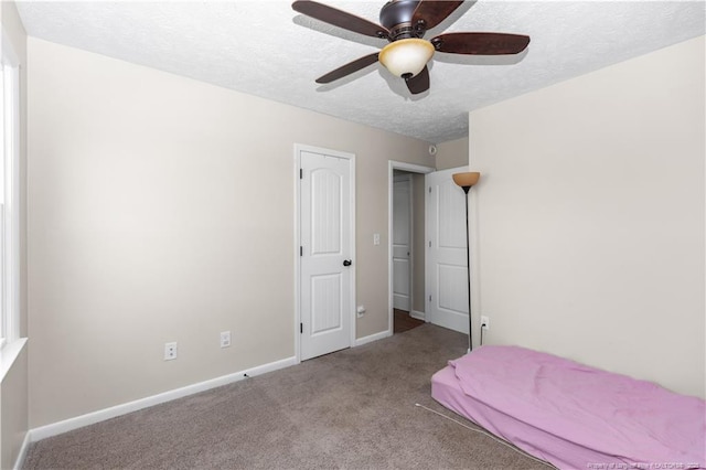 1524 Stackhouse Dr, Fayetteville, NC 28314 - carpeted bedroom with a textured ceiling and a ceiling fan