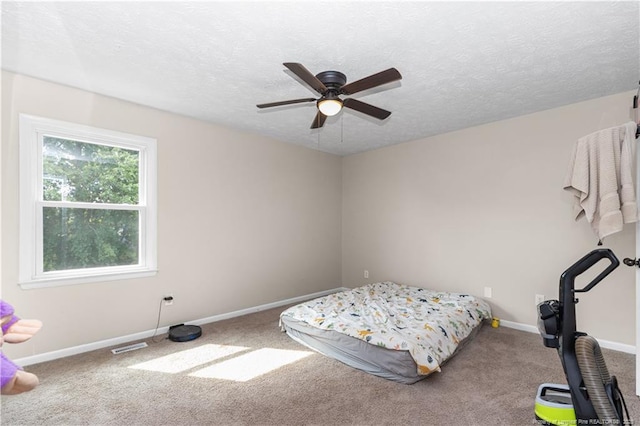 1524 Stackhouse Dr, Fayetteville, NC 28314 - bedroom featuring carpet flooring, a textured ceiling, and ceiling fan