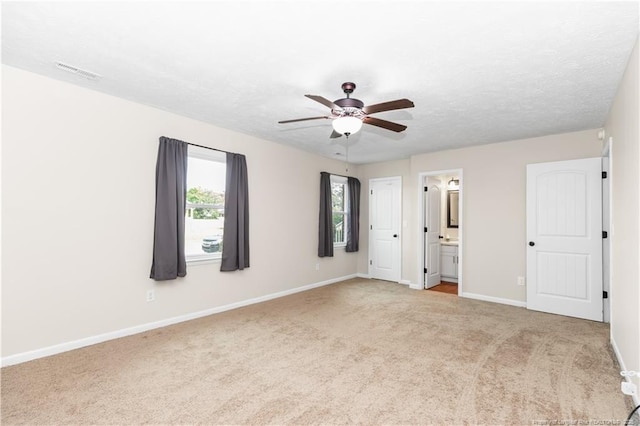 1524 Stackhouse Dr, Fayetteville, NC 28314 - unfurnished bedroom featuring carpet floors, connected bathroom, and ceiling fan