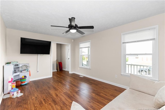 1524 Stackhouse Dr, Fayetteville, NC 28314 - unfurnished living room with wood finished floors, a ceiling fan, and a textured ceiling