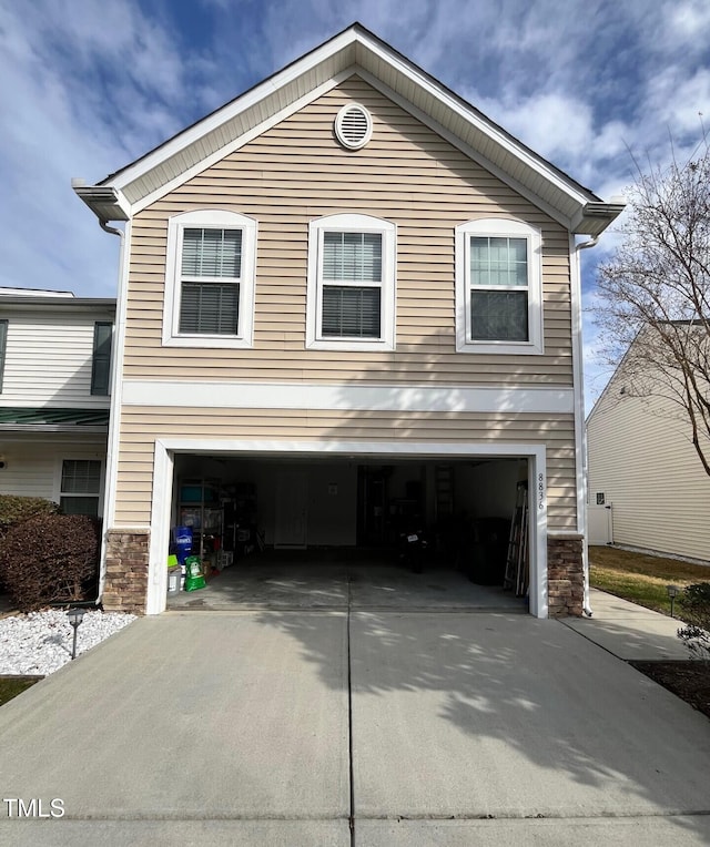 8836 Thornton Garden Ln, Raleigh, NC 27616 - view of property exterior with a garage, concrete driveway, and stone siding