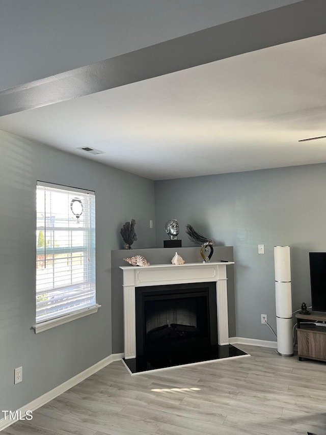 8836 Thornton Garden Ln, Raleigh, NC 27616 - living room with a fireplace with raised hearth and wood finished floors