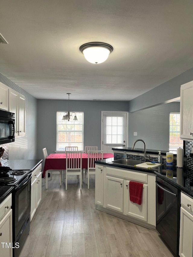 8836 Thornton Garden Ln, Raleigh, NC 27616 - kitchen featuring black appliances, dark countertops, and white cabinetry