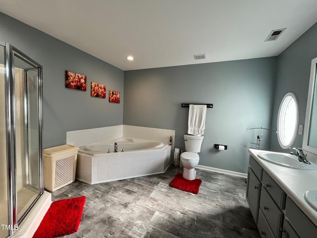 8836 Thornton Garden Ln, Raleigh, NC 27616 - bathroom featuring a garden tub, double vanity, a shower stall, wood finished floors, and recessed lighting