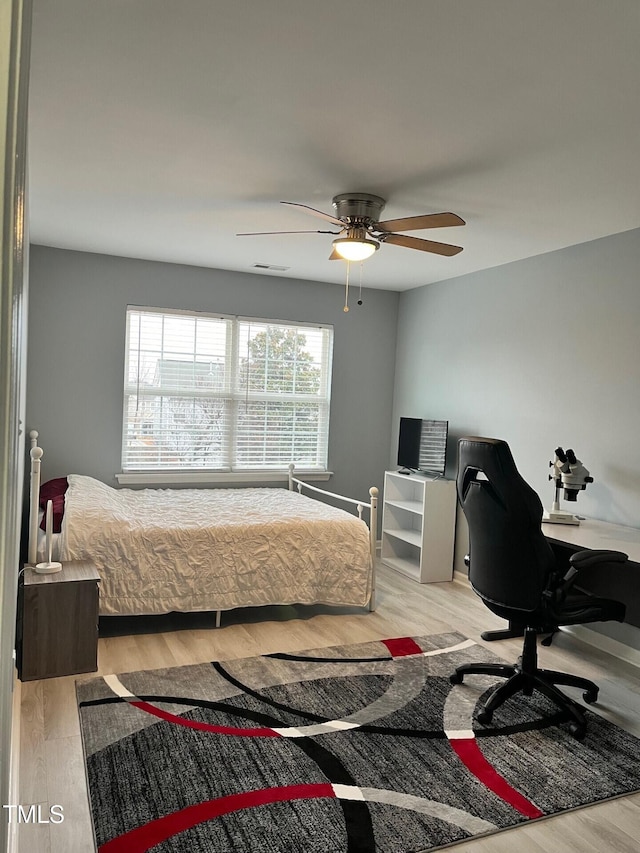 8836 Thornton Garden Ln, Raleigh, NC 27616 - bedroom with wood finished floors, an office area, and ceiling fan