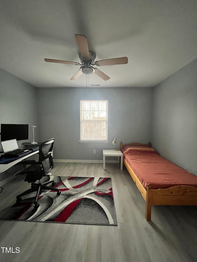 8836 Thornton Garden Ln, Raleigh, NC 27616 - bedroom featuring wood finished floors, a desk, and a ceiling fan