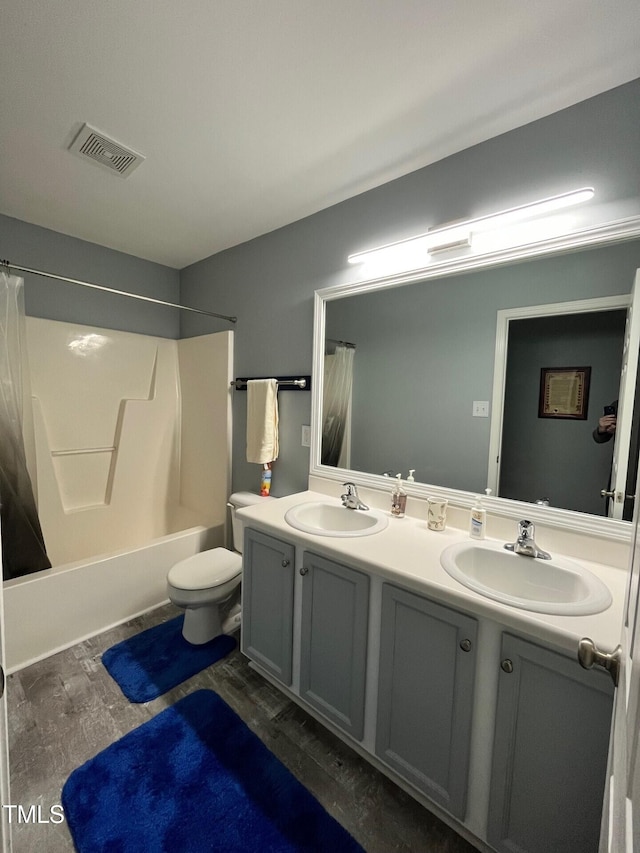 8836 Thornton Garden Ln, Raleigh, NC 27616 - bathroom featuring double vanity, shower / tub combo with curtain, and wood finished floors