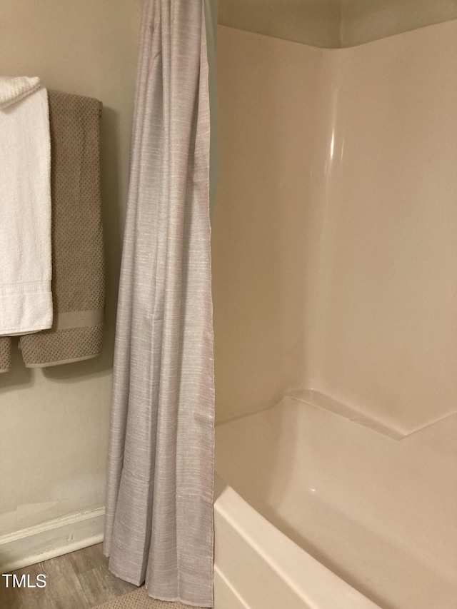 500 Umstead Dr Unit D307, Chapel Hill, NC 27516 - bathroom with shower / tub combo with curtain and wood finished floors