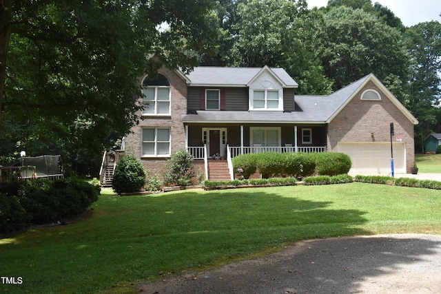 9 Pinecourt Dr, Siler City, NC 27344 - traditional home featuring stairs, a front lawn, a trampoline, and covered porch