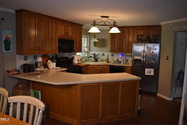 9 Pinecourt Dr, Siler City, NC 27344 - kitchen featuring black appliances, light countertops, a peninsula, brown cabinets, and crown molding