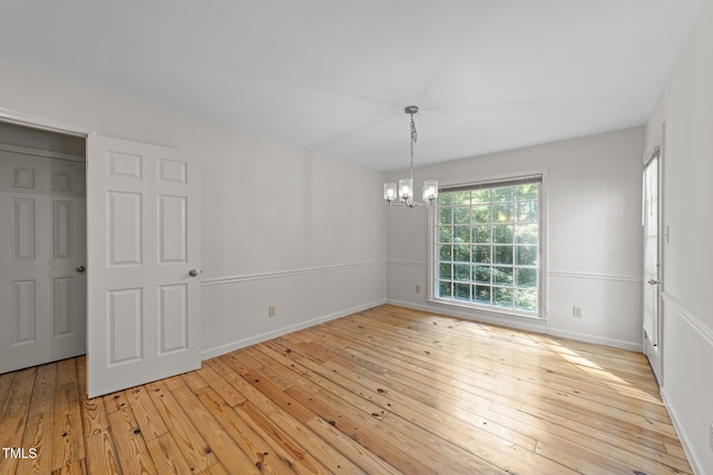 3309 Bearskin Ct, Raleigh, NC 27606 - spare room with a chandelier and light wood finished floors