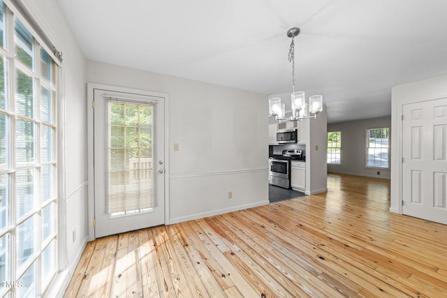 3309 Bearskin Ct, Raleigh, NC 27606 - unfurnished dining area featuring a chandelier and light wood finished floors