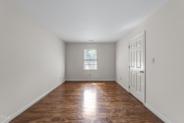 3309 Bearskin Ct, Raleigh, NC 27606 - empty room featuring dark wood-style floors and baseboards