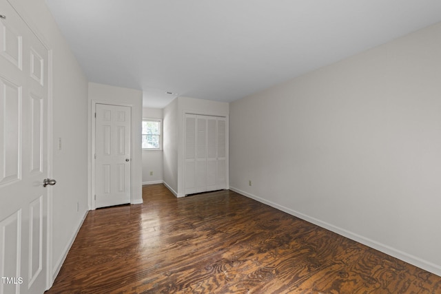 3309 Bearskin Ct, Raleigh, NC 27606 - unfurnished bedroom with dark wood-type flooring and a closet