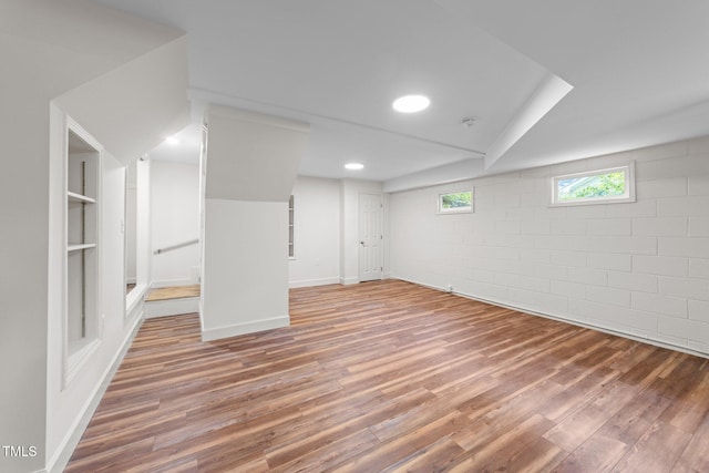 3309 Bearskin Ct, Raleigh, NC 27606 - below grade area with wood finished floors, concrete block wall, and recessed lighting