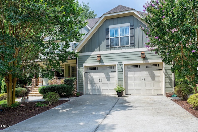 1013 Shasta Daisy Dr, Wake Forest, NC 27587 - view of front of house with board and batten siding, concrete driveway, an attached garage, and roof with shingles