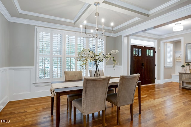 1013 Shasta Daisy Dr, Wake Forest, NC 27587 - dining space with a chandelier, light wood-style floors, a decorative wall, a wainscoted wall, and ornamental molding