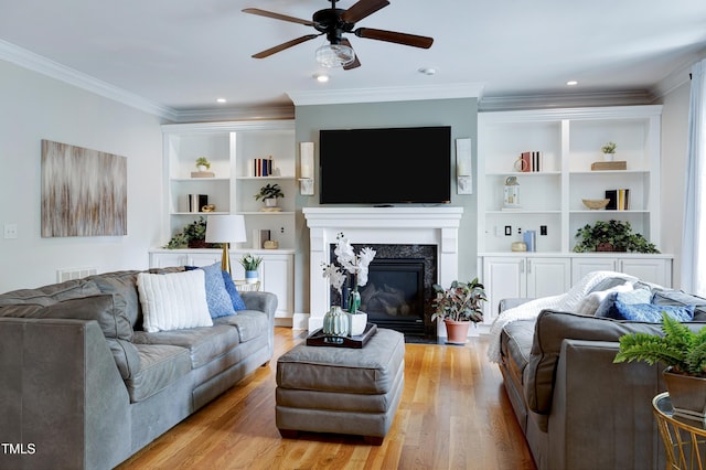 1013 Shasta Daisy Dr, Wake Forest, NC 27587 - living room featuring ceiling fan, light wood-type flooring, a premium fireplace, ornamental molding, and built in shelves