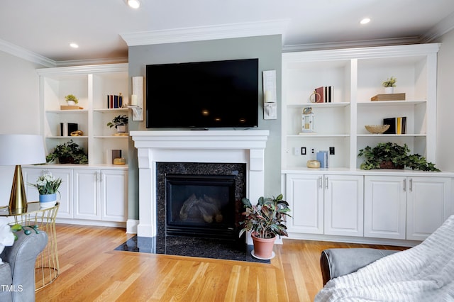 1013 Shasta Daisy Dr, Wake Forest, NC 27587 - living room featuring light wood-style flooring, a high end fireplace, crown molding, and built in features