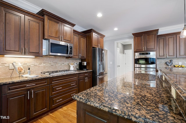 1013 Shasta Daisy Dr, Wake Forest, NC 27587 - kitchen with appliances with stainless steel finishes, ornamental molding, tasteful backsplash, dark stone countertops, and recessed lighting