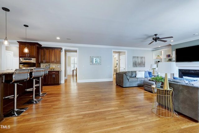 1013 Shasta Daisy Dr, Wake Forest, NC 27587 - living area with a ceiling fan, light wood finished floors, ornamental molding, a premium fireplace, and recessed lighting